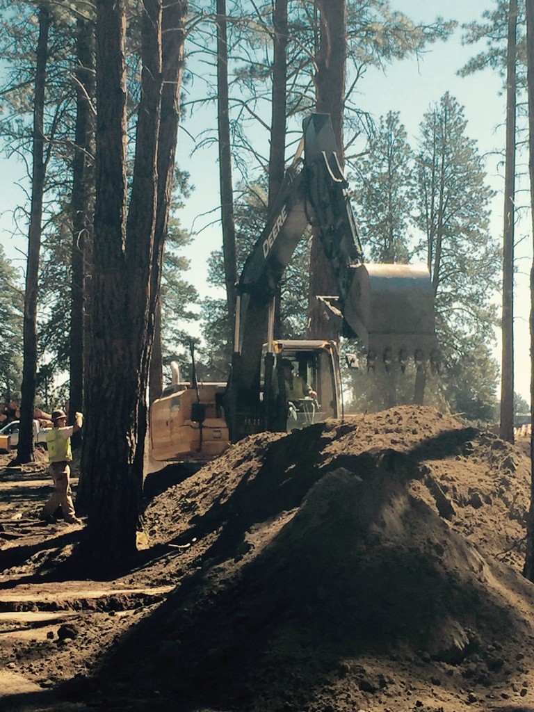 The Hitachi & John Deere excavators hard at work at the FivePine Lodge project in Sisters, Oregon.  Today the crew was digging trenches for the sewer line. Working amongst the pine trees can't be all bad.
